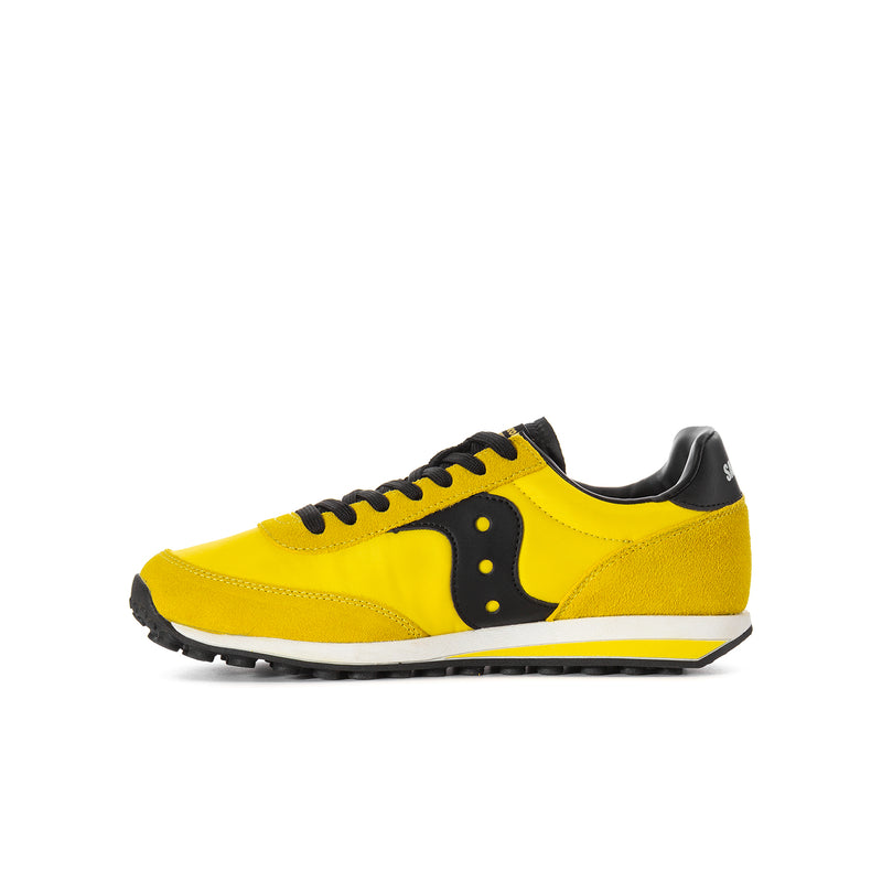 Youth lace-up running shoe side profile, yellow upper with black logo and tread