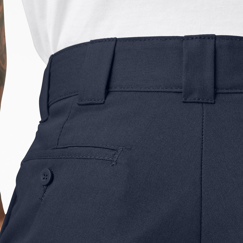 Dark navy twill cargo pants waistband close-up with belt loops and button fly