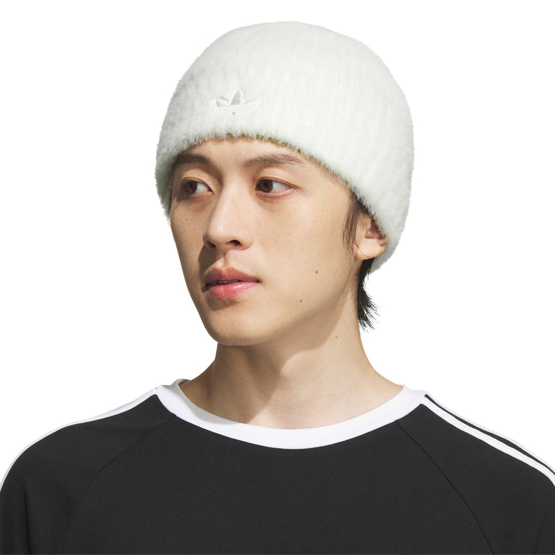 Off-white knit beanie with cuff and trefoil logo, worn on model