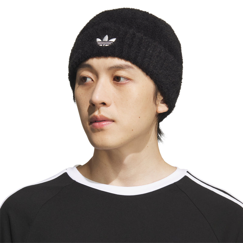 Black beanie worn on model, with small white trefoil logo