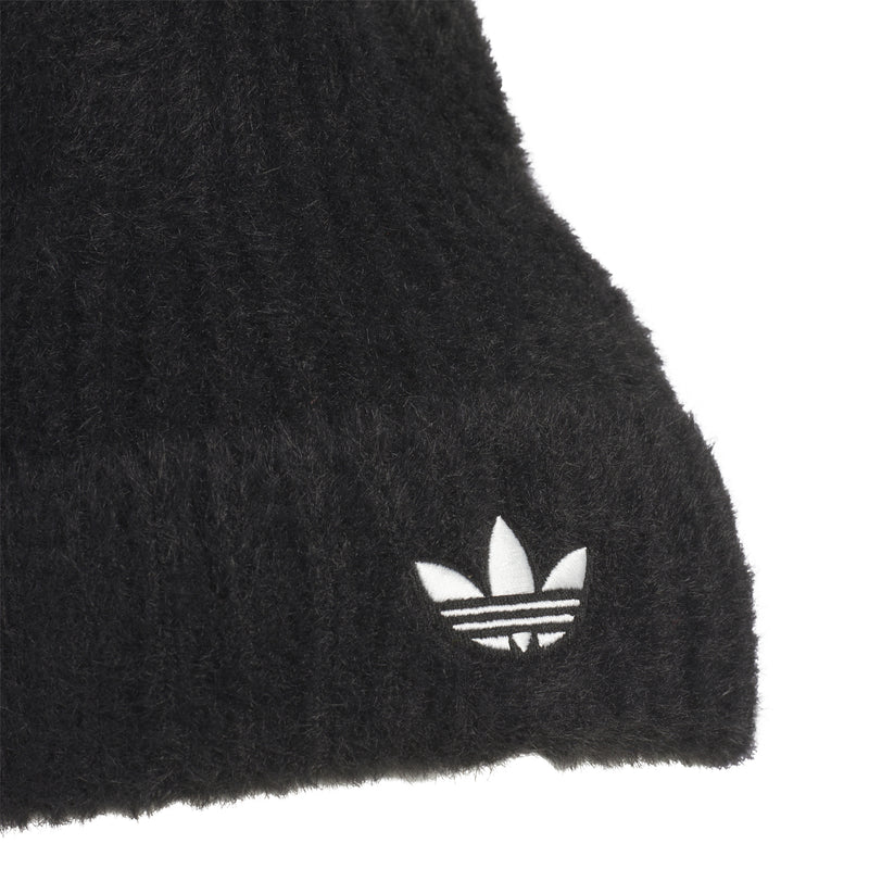 Close-up of black knit beanie cuff with white trefoil logo