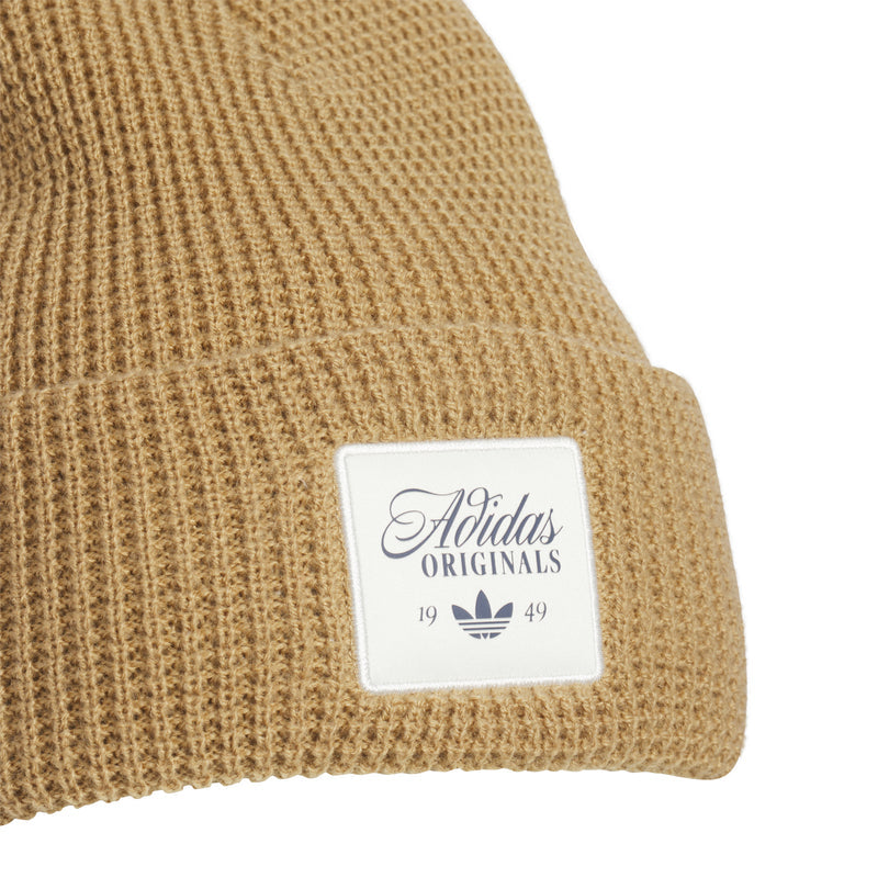 Waffle-knit brown beanie close-up with Adidas Originals logo patch on cuff