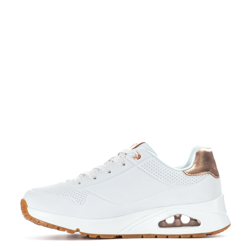Youth white sneaker with rose-gold eyelets, lace-up, and brown outsole tread