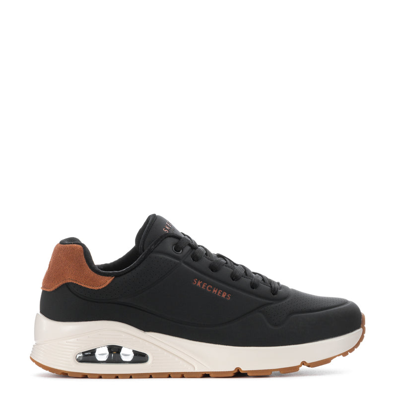 Men's black low-top sneakers with tan collar, white midsole, Air heel detail