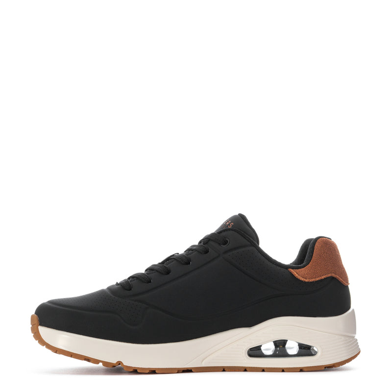 Men's black low-top sneaker, side profile with tan lining and white midsole