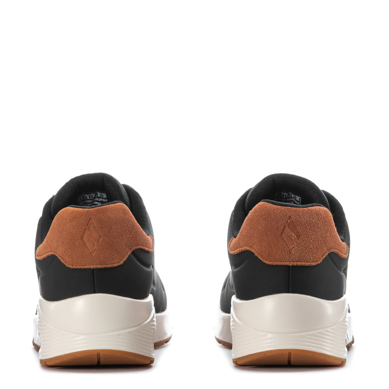 Men's black low-top sneakers heel view with tan suede collar and white sole