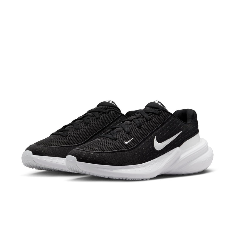 Black mesh women's running sneaker with white Nike swoosh and thick white sole