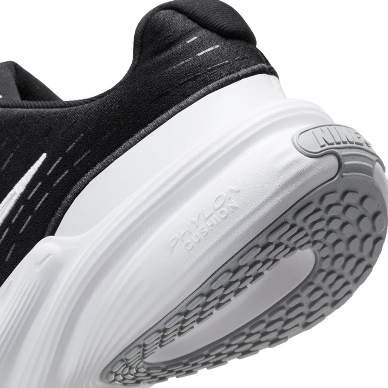 Close-up of black upper and white outsole tread on women's running sneaker