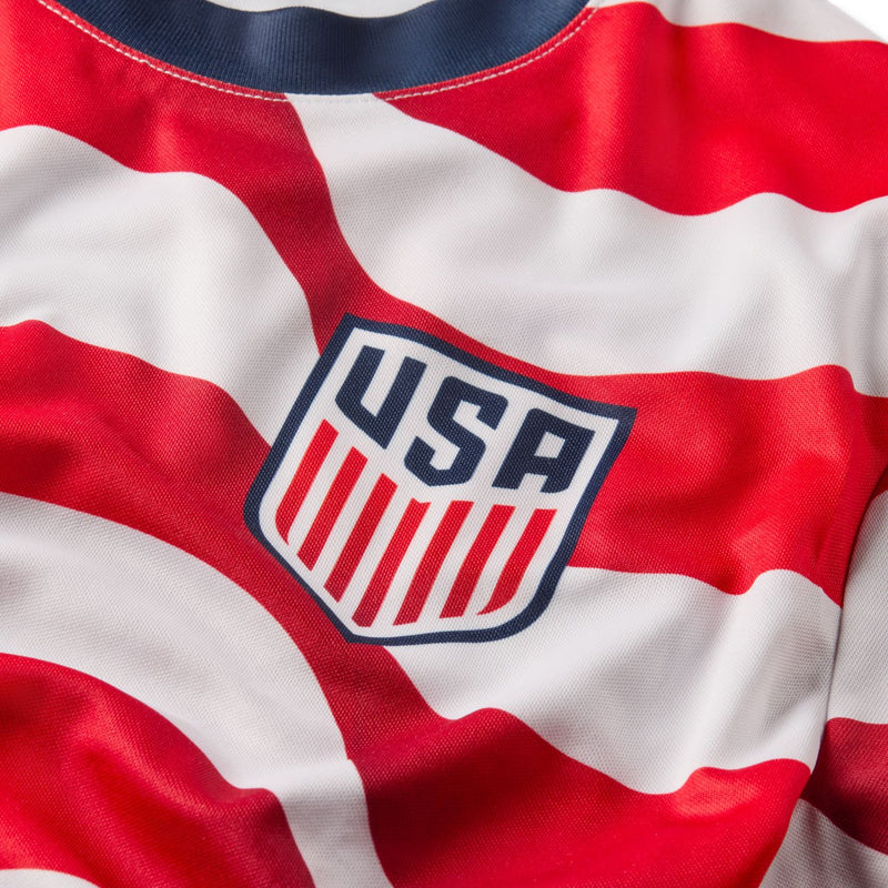 USA supporter tee close-up: U.S.A. shield logo on red and white striped fabric