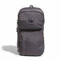 Grey utility sling bag with front zip pockets and logo patch