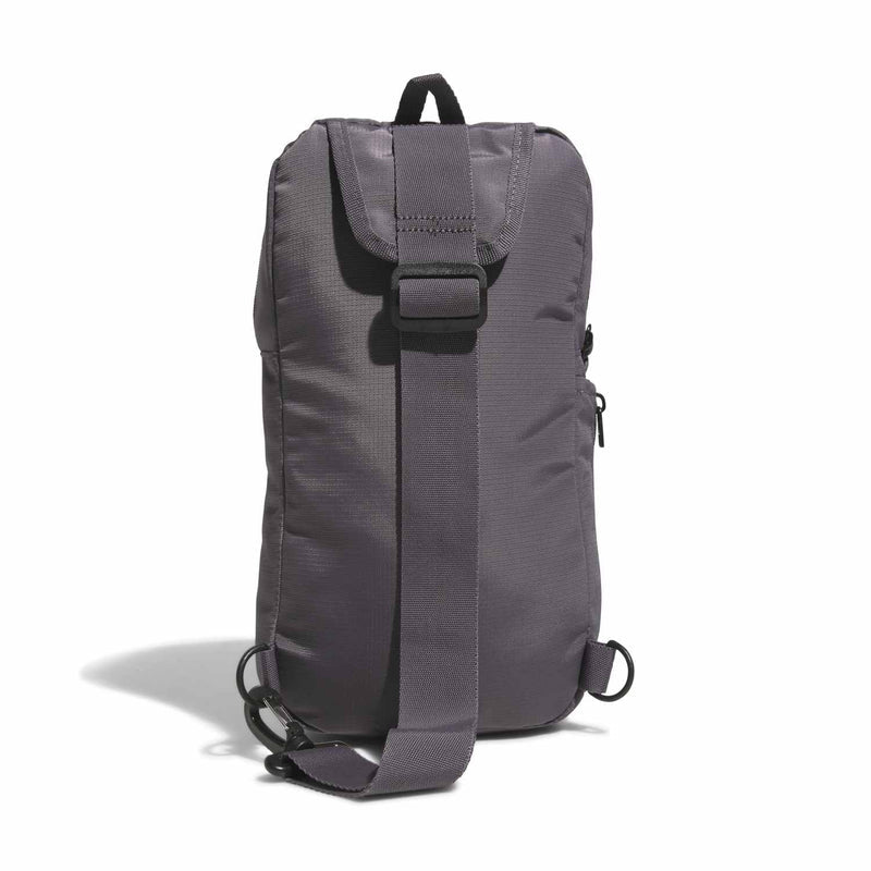 Grey sling bag with adjustable strap, top handle, and side buckle