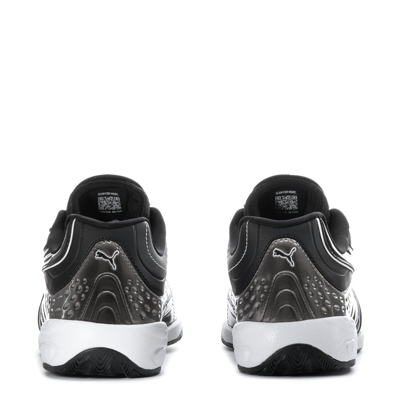 Black Puma sneakers with perforated panels, white heel sole, back pull-tab