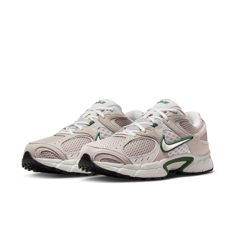 Pair of light gray sneakers with green accents, mesh uppers, and cushioned sole