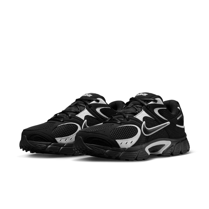 Men's black and white lace-up Nike running shoes, side view with mesh panels