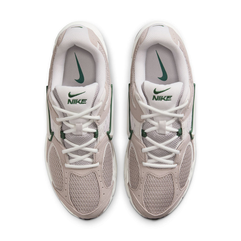 Front view of light gray NIKE sneakers with green swoosh logos and white laces