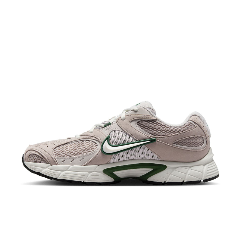 Side view of light gray running shoes with green swoosh and textured mesh panels