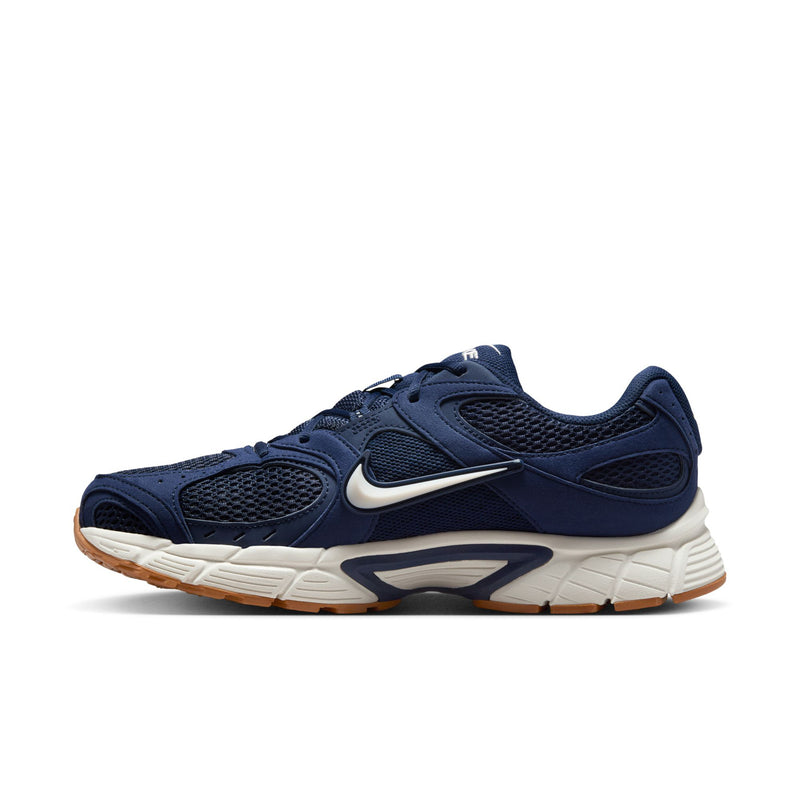 Men's navy lace-up sneakers with white midsole, tan outsole, and swoosh