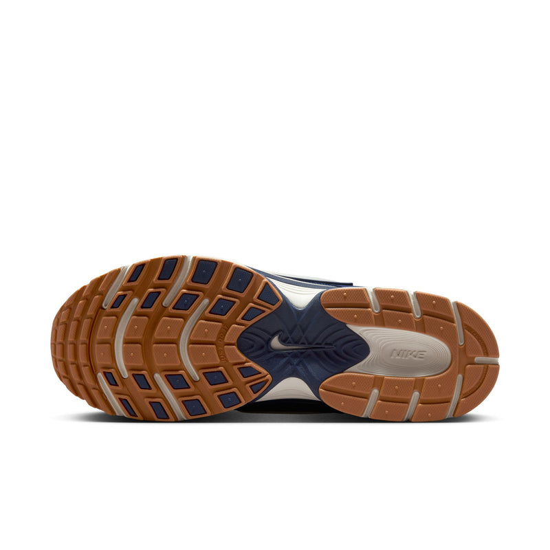 Shoe outsole view showing tan rubber tread and blue heel grip