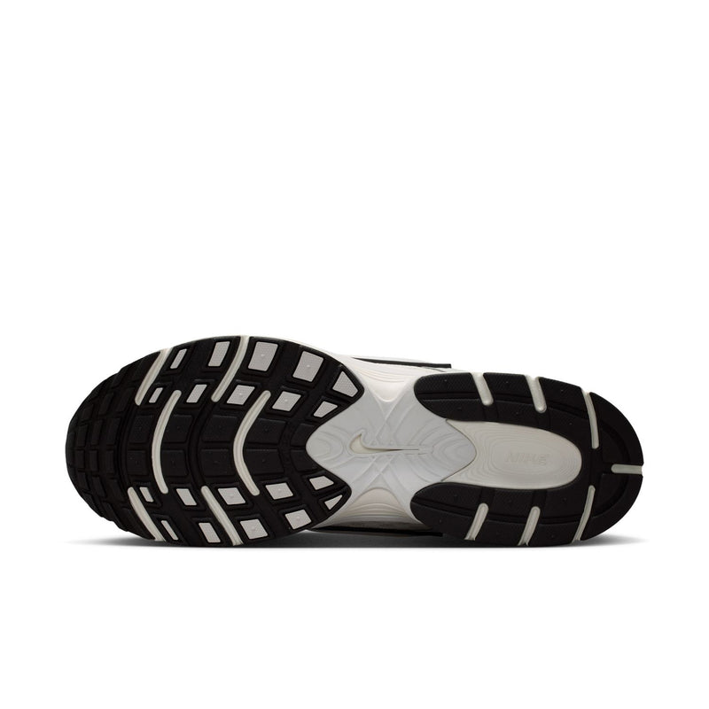 Men's running shoe outsole, black tread with white foam midsole and dark side stripes