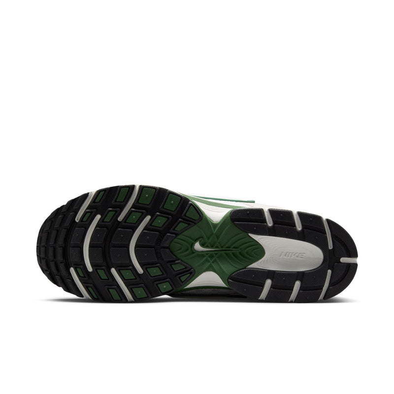 Outsole view of light gray and green sneakers with black tread pattern