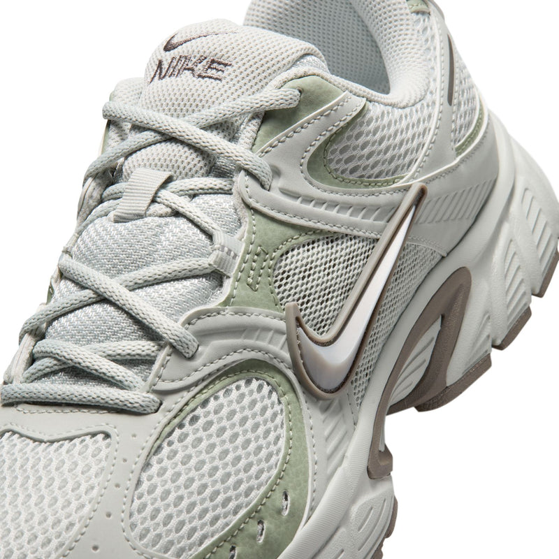 Men's running shoe close-up, light silver mesh with lace-up and swoosh branding