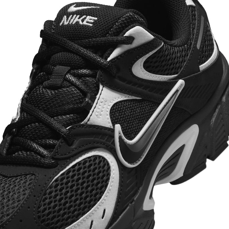 Men's black Nike running shoe close-up with swoosh overlays and lace detail