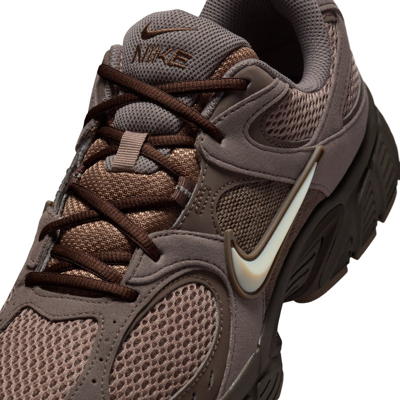 Men's running shoes close-up, lace-up mesh upper with Nike swoosh and cushioned tongue