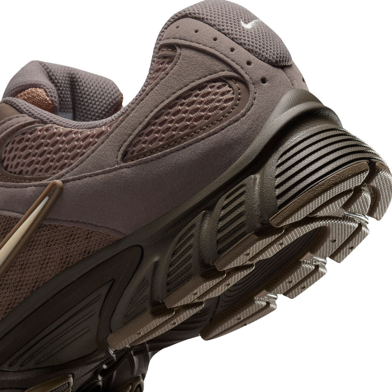 Men's running shoes close-up side, textured panels with ribbed outsole tread detail