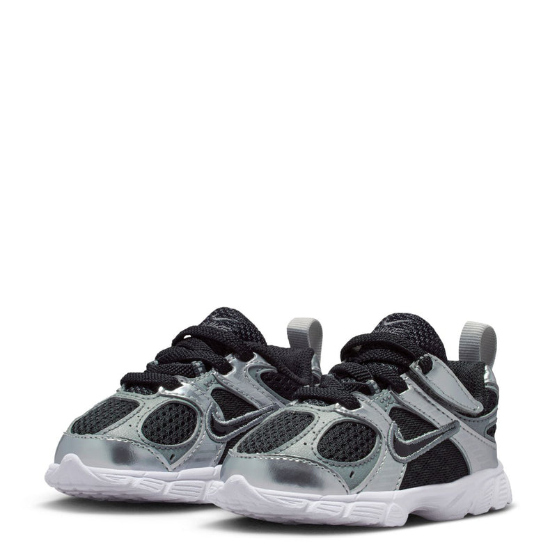 Pair of toddler sneakers in silver and black with black laces and white tread sole