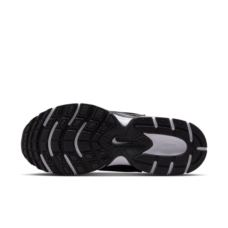Men's running shoe outsole in black with white midfoot and grooved traction pattern.