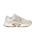 Women’s athletic sneaker in white with tan/gold accents and chunky sole