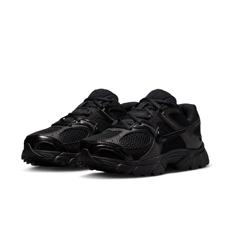 Black womens wide athletic sneaker, lace-up design, textured upper, Nike Swoosh visible.