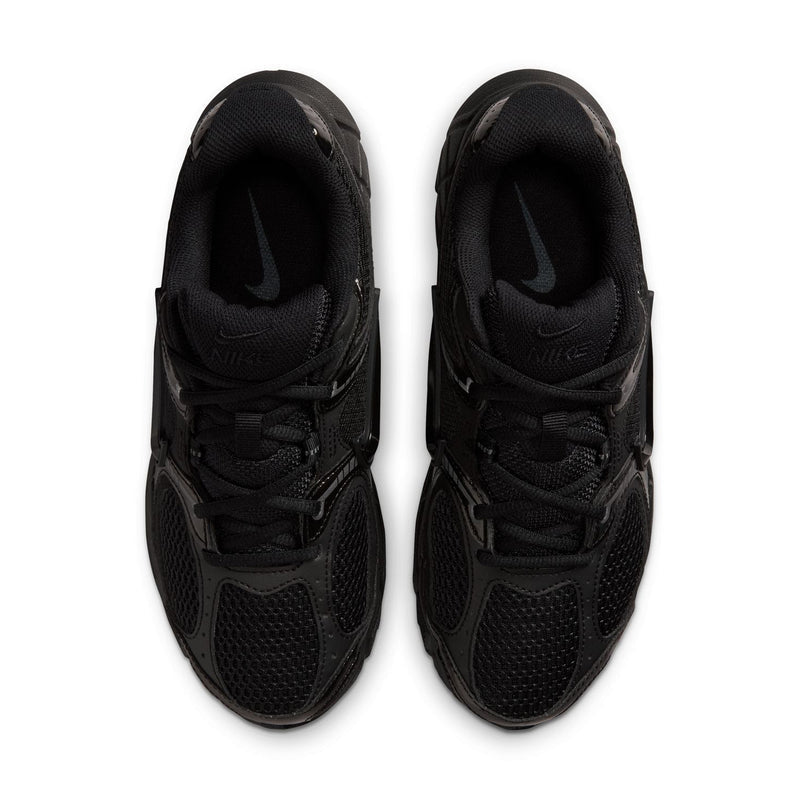 Black womens wide athletic sneakers, front view with lace-up and Nike Swoosh on tongue.
