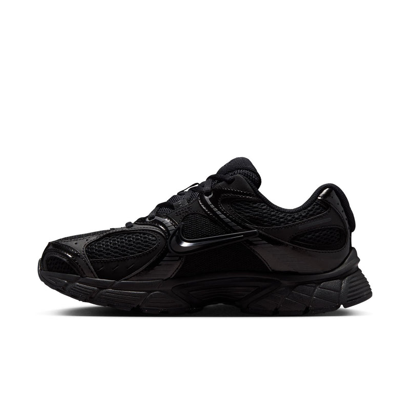 Black womens wide athletic sneaker side view with lace-up and layered synthetic panels.
