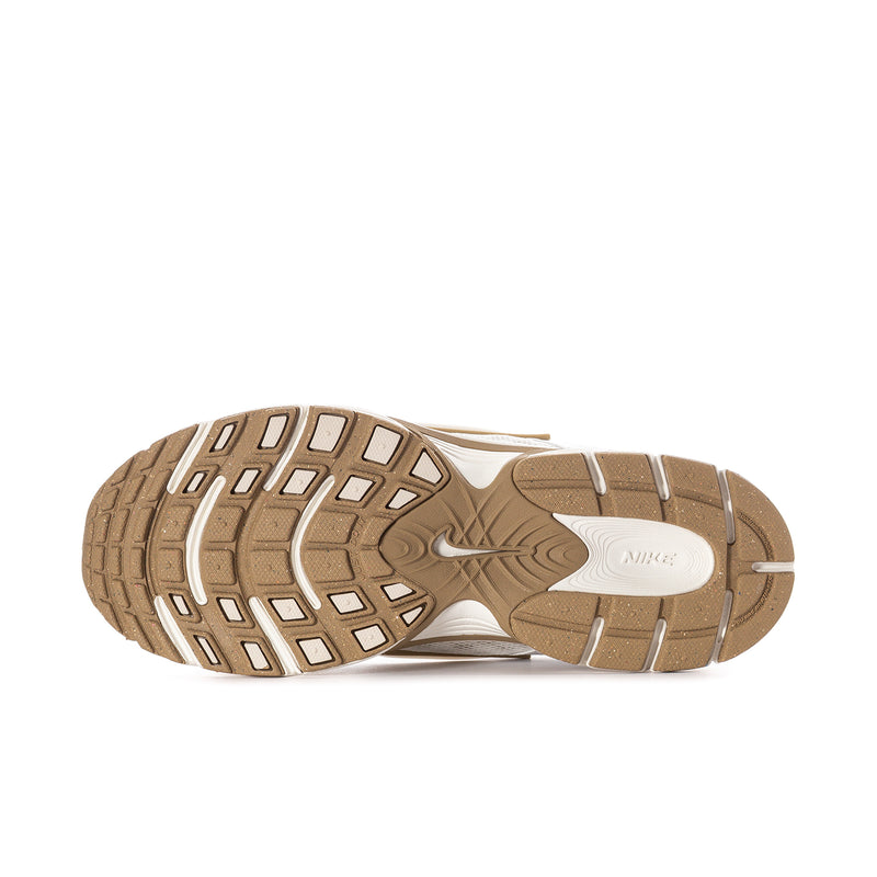Women’s sneaker outsole tread in tan with white midsole, rugged traction pattern