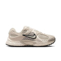 Womens cream lace-up running sneaker with Nike Swoosh and black accent trim