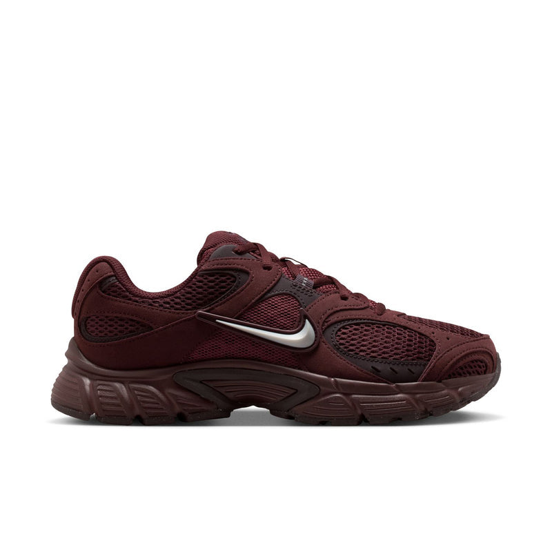 Women's burgundy athletic sneakers with silver swoosh and textured upper