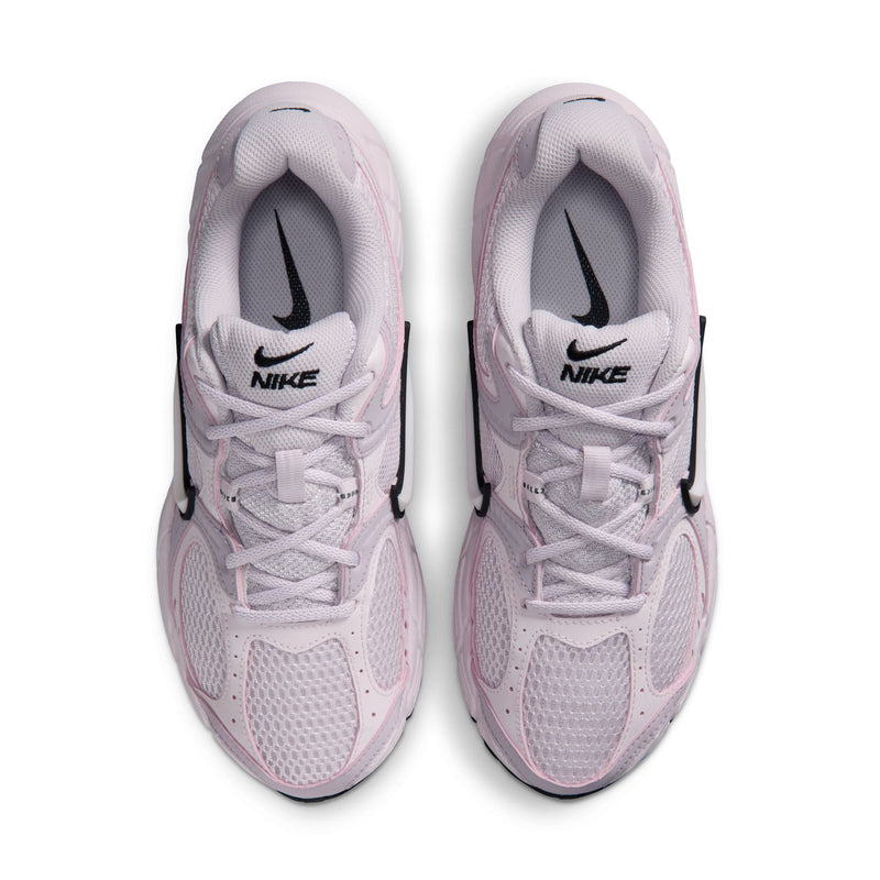 Lilac Nike lace-up sneakers with black heel pull and Nike branding on tongue