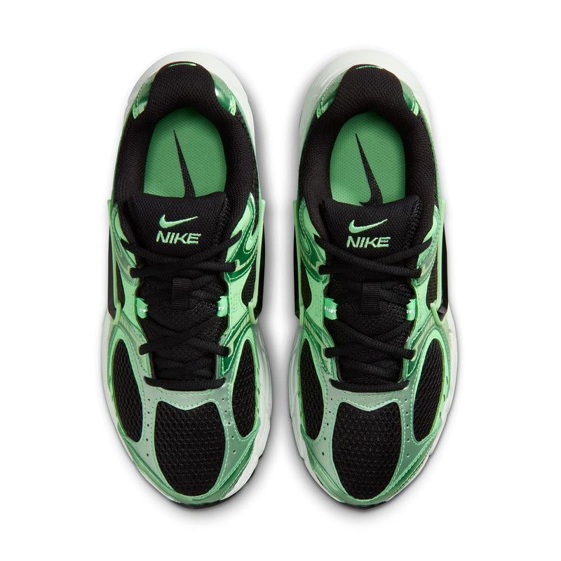 Pair of women's green running shoes with black laces and Nike branding on tongues