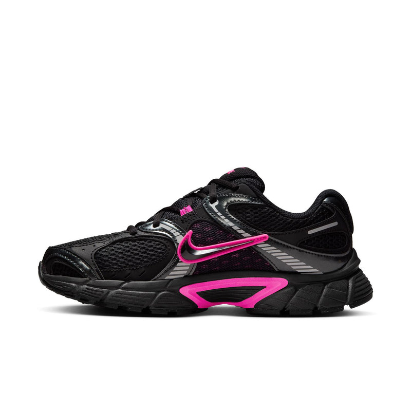 Women's black running shoes with pink swoosh and geometric stripes, lace-up