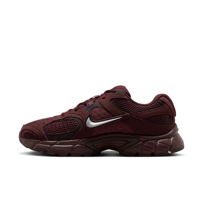 Women's burgundy athletic sneakers with silver swoosh and cushioned midsole
