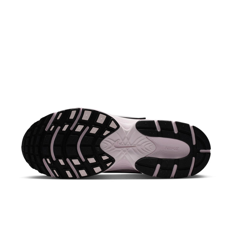 Lilac Nike sneaker outsole with black tread pattern and foam midsole
