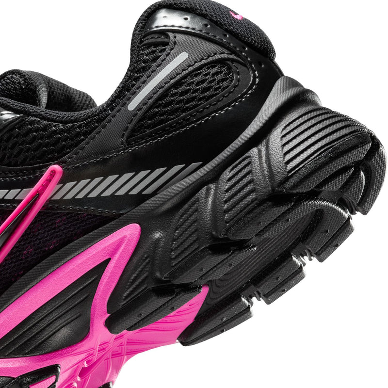 Women's black shoe with pink trim and textured grip outsole detail