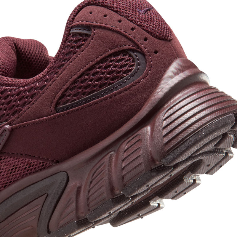 Women's burgundy sneaker side with ridged midsole and silver-toned outsole