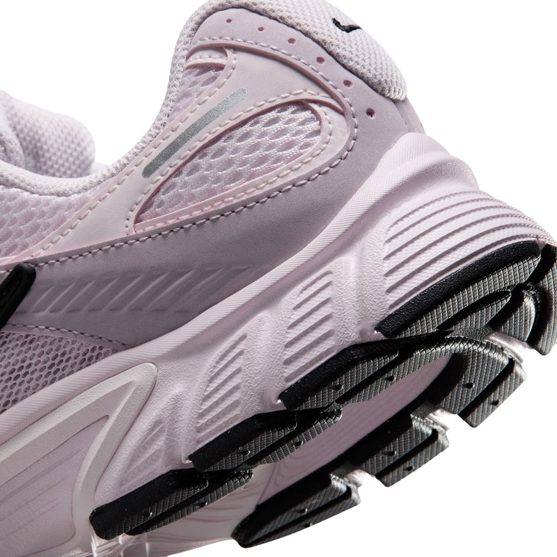 Lilac Nike sneaker close-up: ribbed midsole and black traction outsole