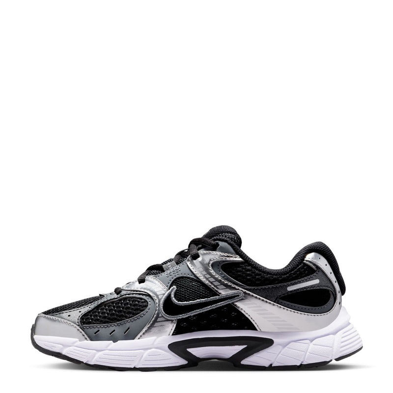 Black and silver youth running shoes, side view with Nike logo and sculpted sole