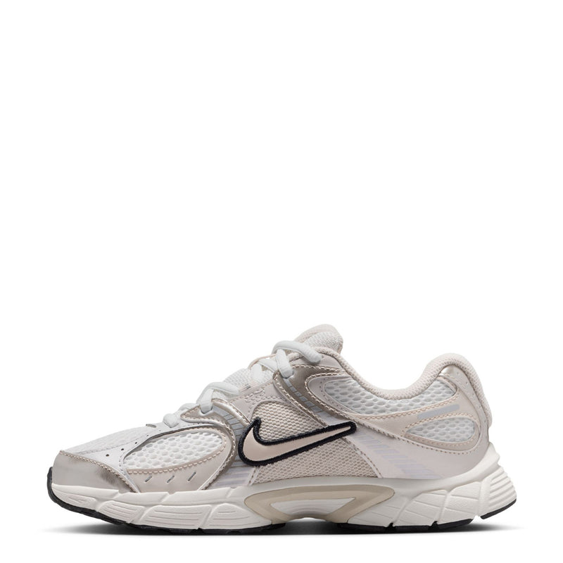 Youth white running sneaker, angled side view with black swoosh and lace-up front