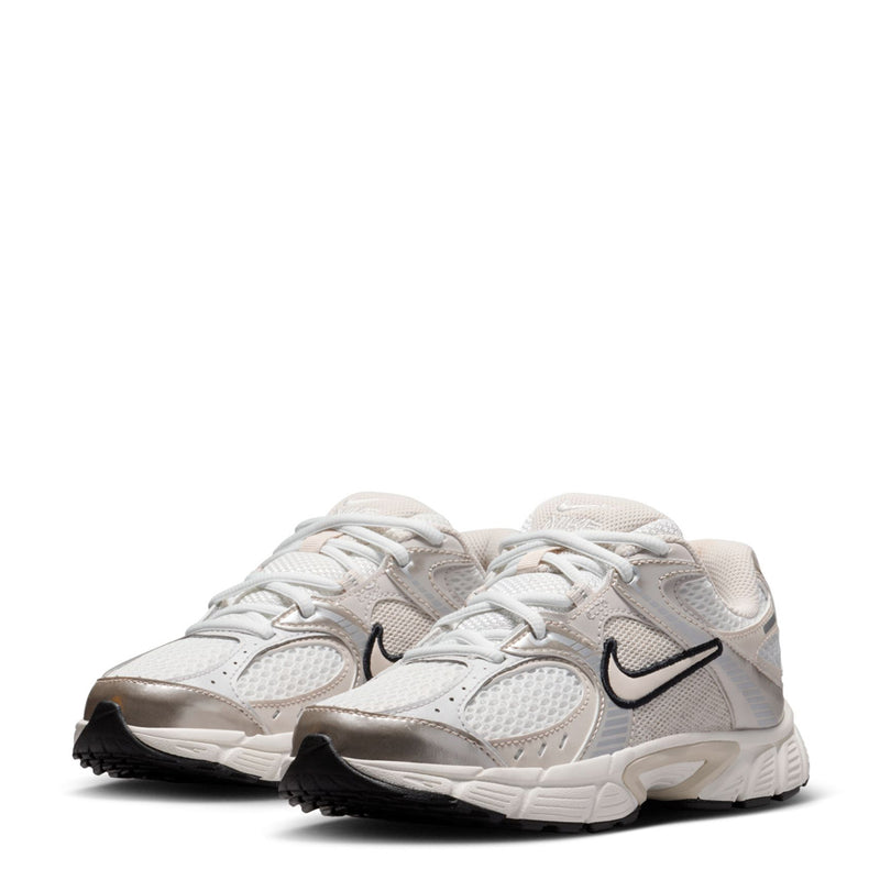 Youth white running shoes, front-to-side view with black swoosh and textured overlays