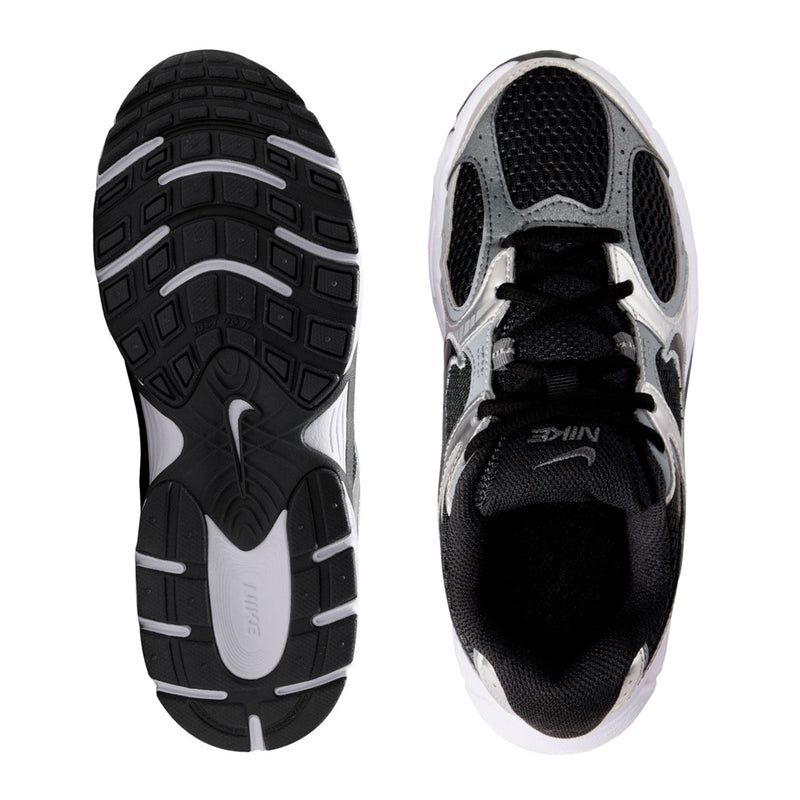Youth running shoes showing black rubber outsole and white interior, lace-up pair