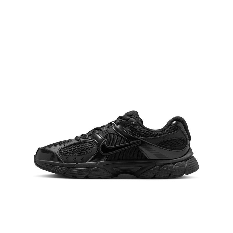 Youth black running shoes in side view with swoosh-style logo and lace-up closure.
